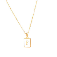 Load image into Gallery viewer, Gold initial necklace with the letter “F” on a mother of pearl pendant, hanging from a dainty gold chain, displayed on a white background.