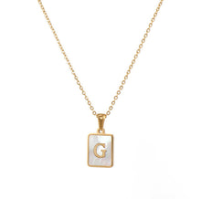 Load image into Gallery viewer, Gold initial necklace with the letter “G” on a mother of pearl pendant, hanging from a dainty gold chain, displayed on a white background.