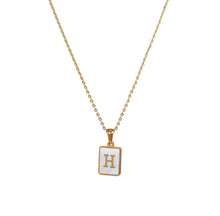 Load image into Gallery viewer, Gold initial necklace with the letter “H” on a mother of pearl pendant, hanging from a dainty gold chain, displayed on a white background.