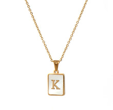 Load image into Gallery viewer, Gold initial necklace with the letter “K” on a mother of pearl pendant, hanging from a dainty gold chain, displayed on a white background.