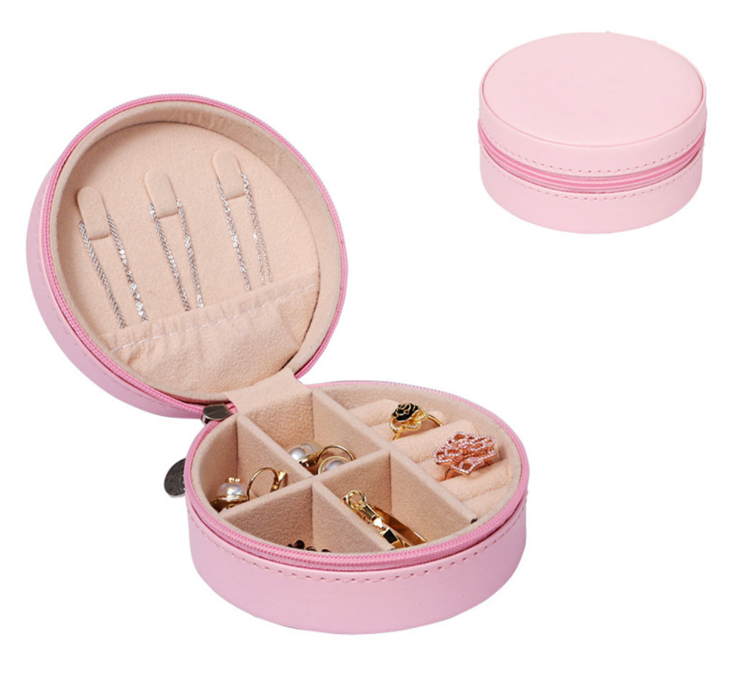 Open pink compact travel jewelry box with zip closure and velvet interior